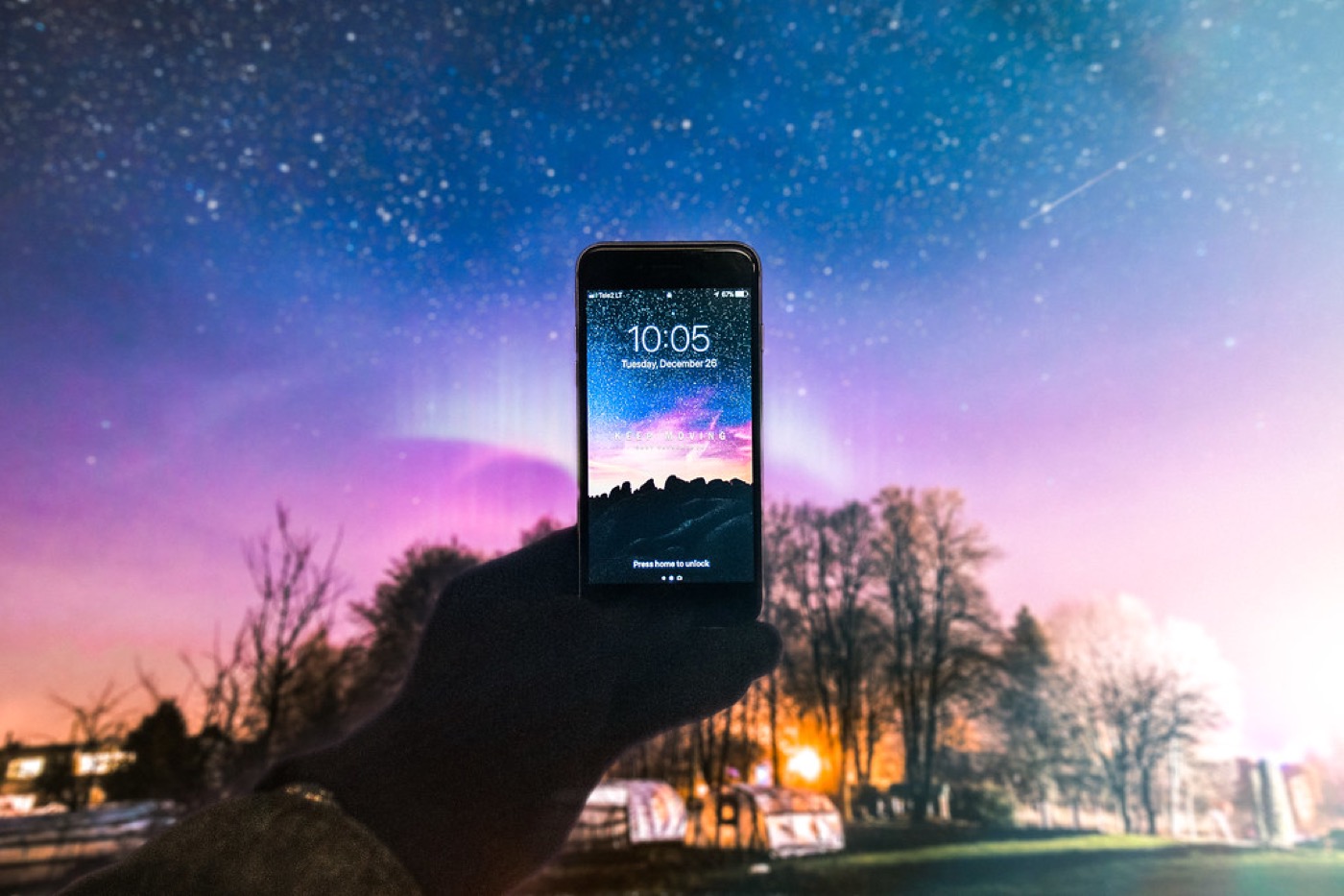 A phone held up against a night sky